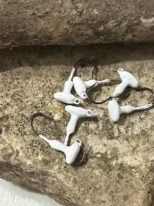 White powder paint on jig heads — finished jig heads painted with Family Fishin white powder paint